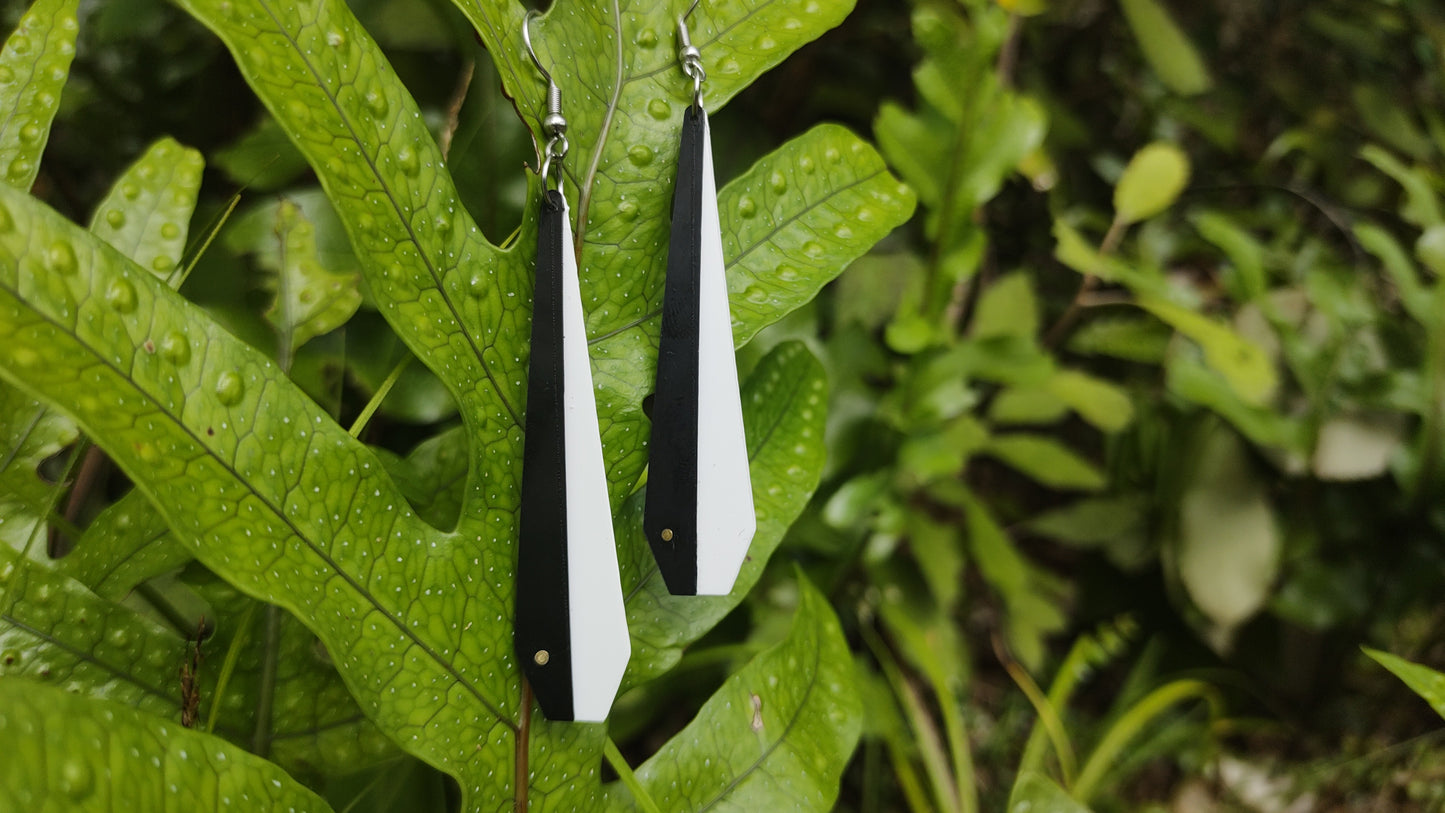 Pīwakawaka Fantails recycled plastic earrings hanging on a fern, Made in NZ