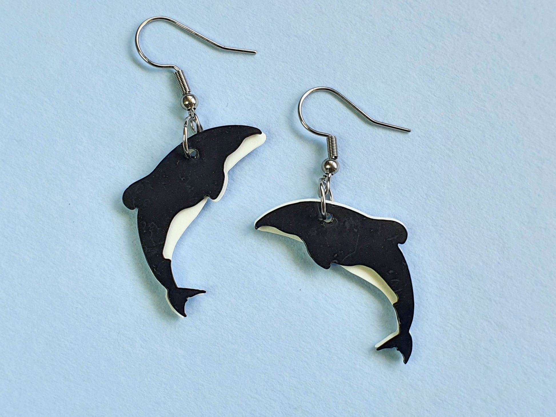 Hector's dolphin earrings laser cut from ice cream container lids by Remix Plastic in Christchurch, NZ